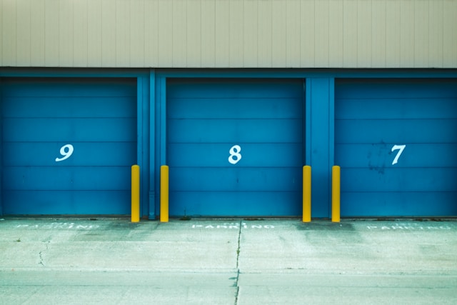 Three blue numbered storage unit doors